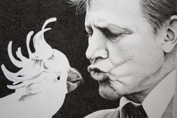 Detail shot of David Attenborough kissing a cockatoo
